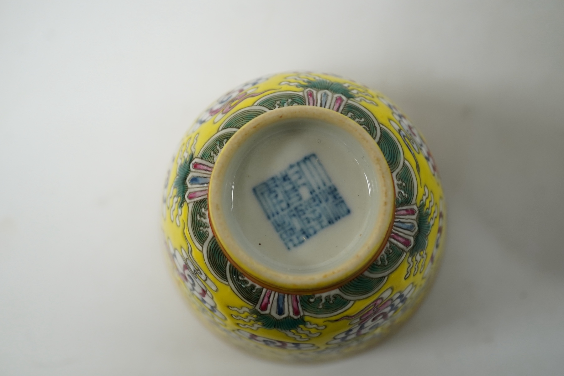 A Chinese porcelain yellow-ground tea cup and saucer, 13cm diameter. Condition - good